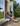 Woman sitting by a window with a garden view in a blue mohair cardigan.