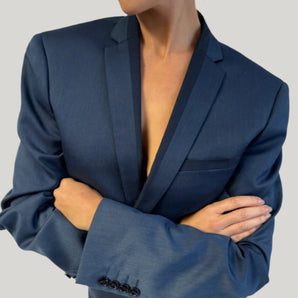 Model wearing upcycled blue blazer set, transformed from a men's blazer into a cropped jacket and high-waisted mini skirt.