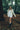 Woman walking through a forest wearing a Cream alpaca wool cardigan
