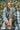Woman sitting on a plaid blanket in a Grey textured alpaca wool jumper in a forest with fallen leaves