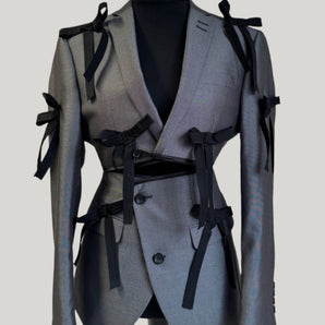 Upcycled grey with bows blazer set, transformed from a men's blazer into a cropped jacket and high waisted mini skirt.