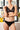 Ensemble de lingerie noire d'une marque de lingerie éthique, soutien gorge triangle en dentelle. 