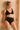 Jeune femme blonde de face porte un ensemble de lingerie noir en coton bio et tulle recyclée de la marque parisienne Olly.