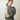 a woman in a grey sweater wears a HYER GOODS convertible python crossbody hobo crescent bag Piccola ring bag #color_python-no-2