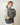 a woman in a grey sweater wears a HYER GOODS convertible python crossbody hobo crescent bag Piccola ring bag #color_python-no-2
