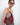 HYER GOODS convertible crossbody hobo Piccola ring bag on the models shoulder #color_dark-cherry-red