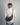 a woman in an oversized white shirt and jeans stands with her back to the camera, with a burgundy crossbody crescent bag draped across her back #color_bordeaux-vintage