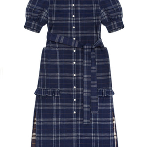 Womens navy check puff sleeve dress, long line with side splits at the hem. The Rosa Dress by Saywood has patch pockets at the hip with ruffles at the bottom of the pockets, with a tied matching belt around the waist. Dress is on a white background.