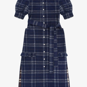 Women's navy check puff sleeve dress, long line with side splits at the hem. The Rosa Dress by Saywood has patch pockets at the hip with ruffles at the bottom of the pockets, with a tied matching belt around the waist. Dress is on a white background.
